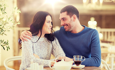 Image showing happy couple drinking tea at restaurant