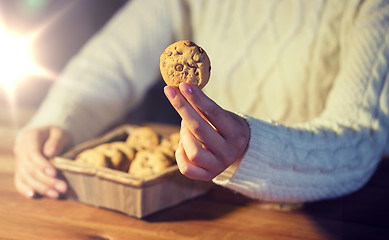 Image showing close up of woman with oat cookies at home