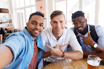 Image showing friends taking selfie and drinking beer at bar