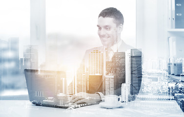 Image showing businessman with laptop and coffee at office