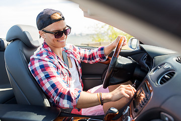 Image showing happy young man driving convertible car