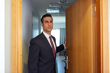 Image showing businessman at hotel room or office door