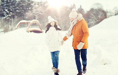 Image showing happy couple walking over winter background