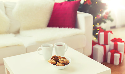 Image showing close up of christmas cookies and cups on table