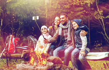 Image showing family with smartphone taking selfie near campfire