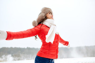 Image showing happy woman in winter fur hat outdoors