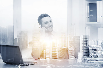 Image showing businessman with laptop and smartphone at office