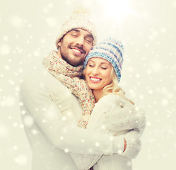 Image showing smiling couple in winter clothes hugging