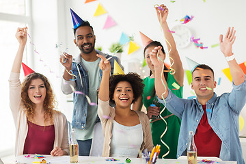 Image showing happy team with confetti at office birthday party