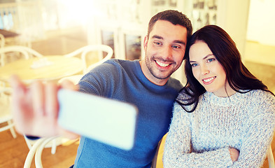 Image showing couple taking smartphone selfie at cafe restaurant