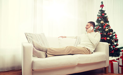 Image showing man calling on smartphone at home for christmas