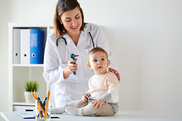 Image showing doctor with baby and otoscope at clinic