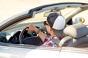 Image showing happy young man in shades driving convertible car