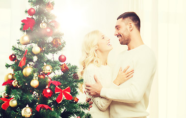 Image showing happy couple hugging near christmas tree at home