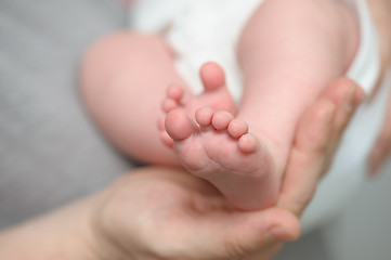 Image showing Mothers hands holding newborn baby feet