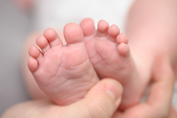 Image showing Mothers hands holding newborn baby feet