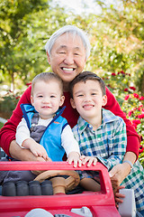 Image showing Happy Senior Adult Chinese Man Playing with His Mixed Race Grand