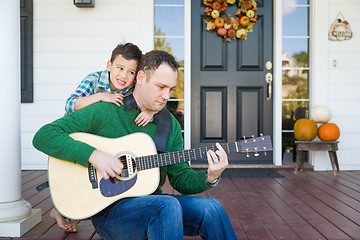 Image showing Young Mixed Race Chinese and Caucasian Son Singing Songs and Pla