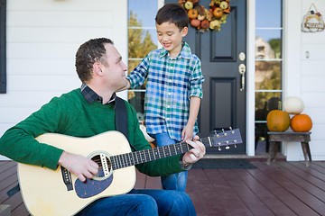 Image showing Young Mixed Race Chinese and Caucasian Son Singing Songs and Pla