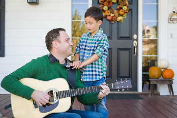 Image showing Young Mixed Race Chinese and Caucasian Son Singing Songs and Pla