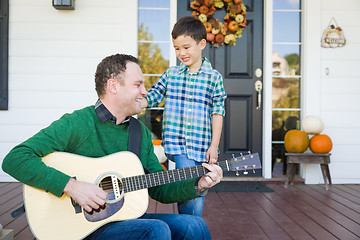 Image showing Young Mixed Race Chinese and Caucasian Son Singing Songs and Pla