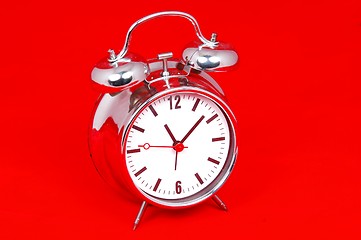 Image showing Table clock on red background