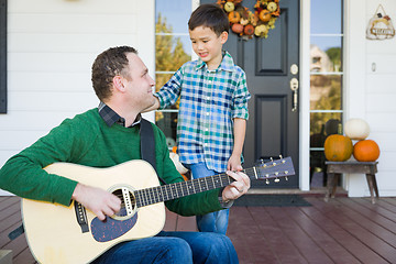 Image showing Young Mixed Race Chinese and Caucasian Son Singing Songs and Pla