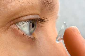 Image showing closeup of woman putting contact lens in her eye