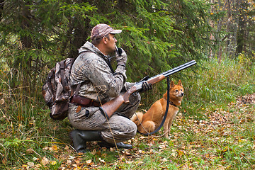 Image showing hunter with a grouse call and shotgun