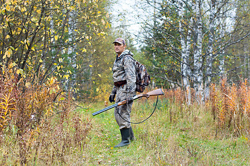 Image showing hunter with shotgun on the autumn hunting