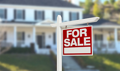 Image showing Home For Sale Real Estate Sign in Front of Beautiful New House.