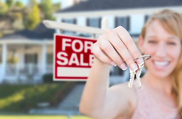 Image showing Excited Woman Holding House Keys and For Sale Real Estate Sign i