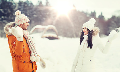 Image showing happy couple playing snowballs in winter