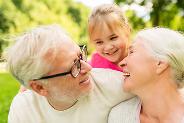 Image showing senior grandparents and granddaughter at park