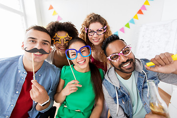 Image showing happy friends or team having fun at office party