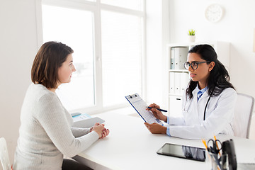 Image showing doctor with clipboard and woman patient at clinic