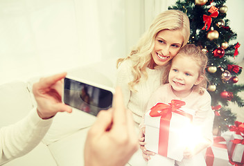 Image showing family taking picture with smartphone at christmas