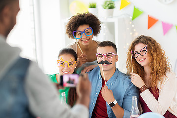 Image showing friends or team photographing at office party