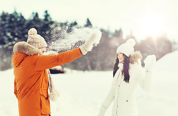 Image showing happy couple playing with snow in winter