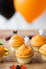 Image showing cupcakes with halloween decoration on table