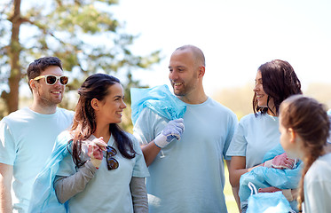 Image showing volunteers with garbage bags walking outdoors