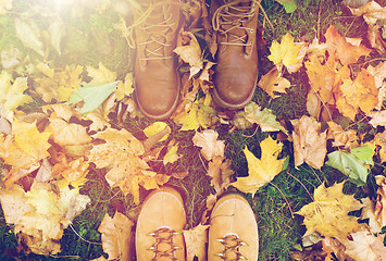 Image showing couple of feet in boots and autumn leaves