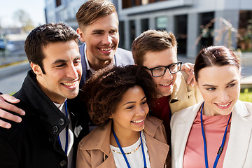 Image showing happy people with conference badges taking selfie