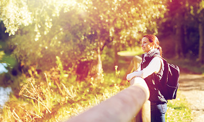 Image showing happy woman with backpack outdoors