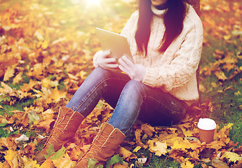 Image showing woman with tablet pc and coffee in autumn park