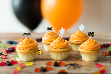 Image showing halloween party cupcakes and candies on table