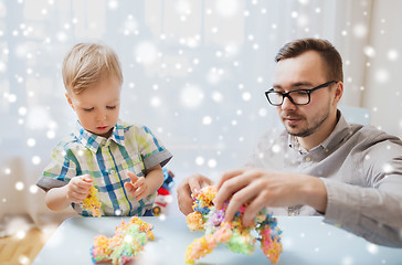 Image showing father and son playing with ball clay at home