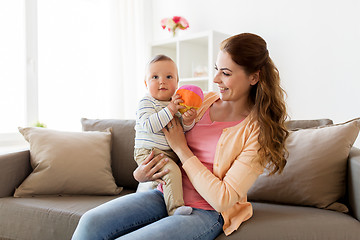 Image showing happy young mother with little baby at home