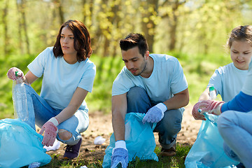 Image showing volunteers with garbage bags cleaning park area