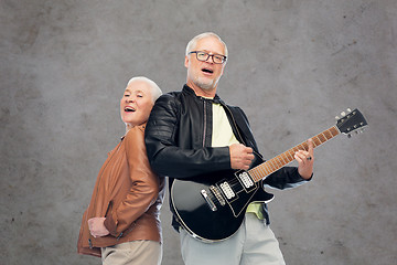 Image showing happy senior couple with electric guitar singing